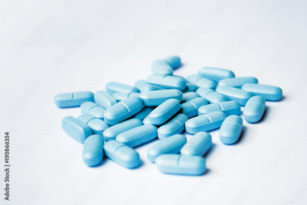 Blue oval tablets closeup on white bakground Blue oval tablets closeup on white bakground