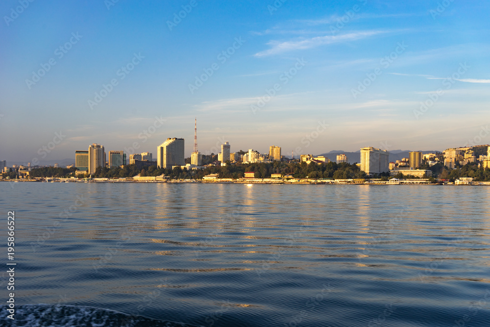 Sea view of the city skyline with modern buildings.
