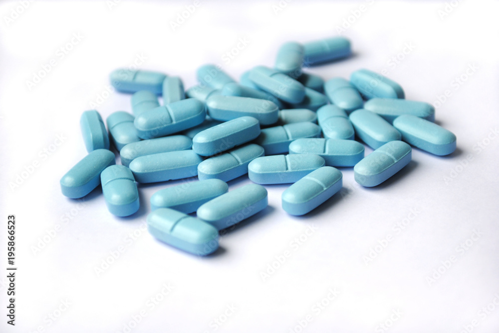 Blue oval tablets closeup isolated
