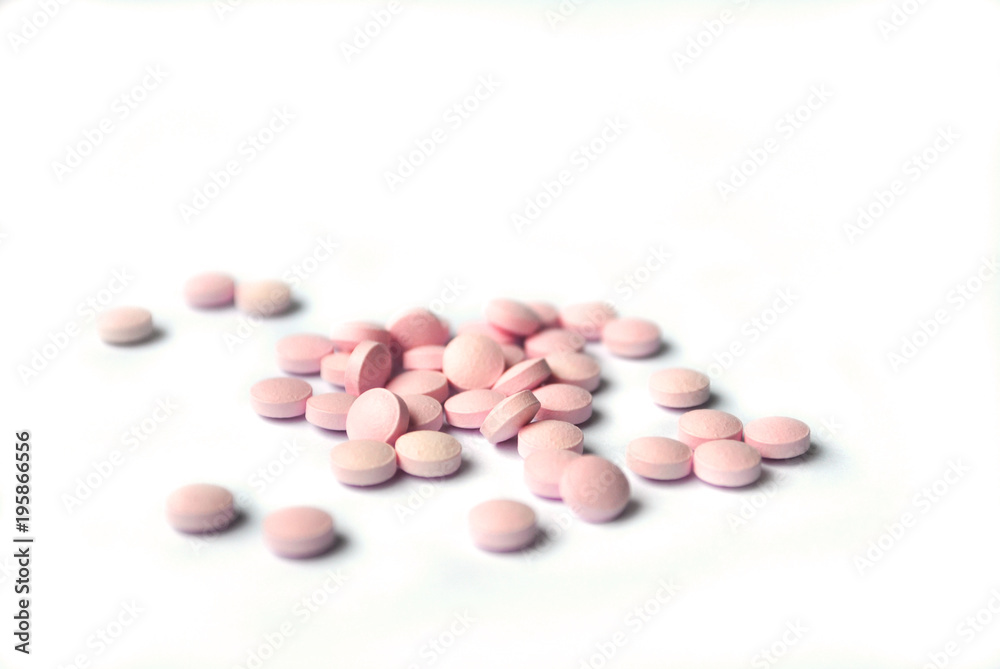 Rose round tablets closeup on white background Rose round tablets closeup on white background