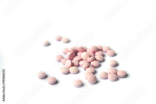 Rose round tablets closeup on white background