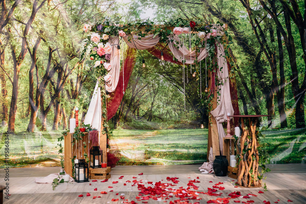 Wedding ceremony arch, altar decorated with flowers on the lawn