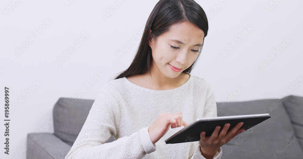 Woman using tablet computer at home Woman using tablet computer at home