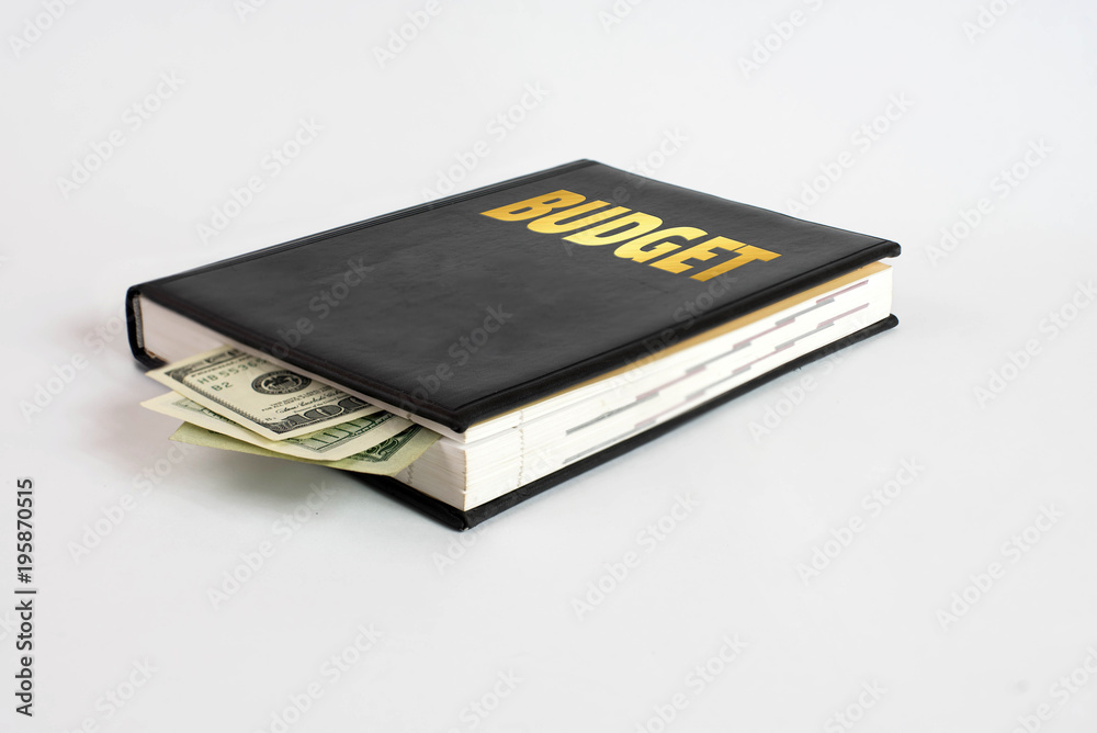 Black book with money and the inscription budget on white background Black book with money and the inscription budget on white background