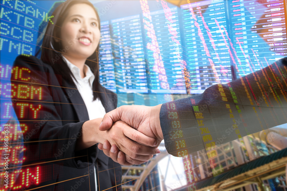 Double exposure of Business handshake ,Investment concept,stock market and city scape screen background Double exposure of Business handshake ,Investment concept,stock market and city scape screen background