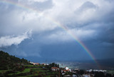 Rainbow in the mountains. Strong rainbow after rain. Fairyland.