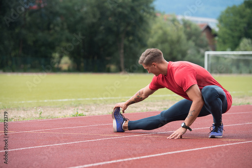 Male Runner Stretching Before Workout