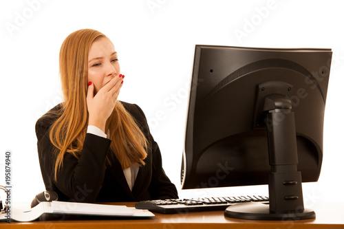 Beautiful youn g business woman yawning on work in office - exaustion on work photo