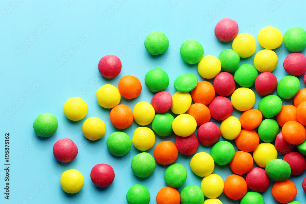 Obraz premium Colorful sweet candies on a blue background