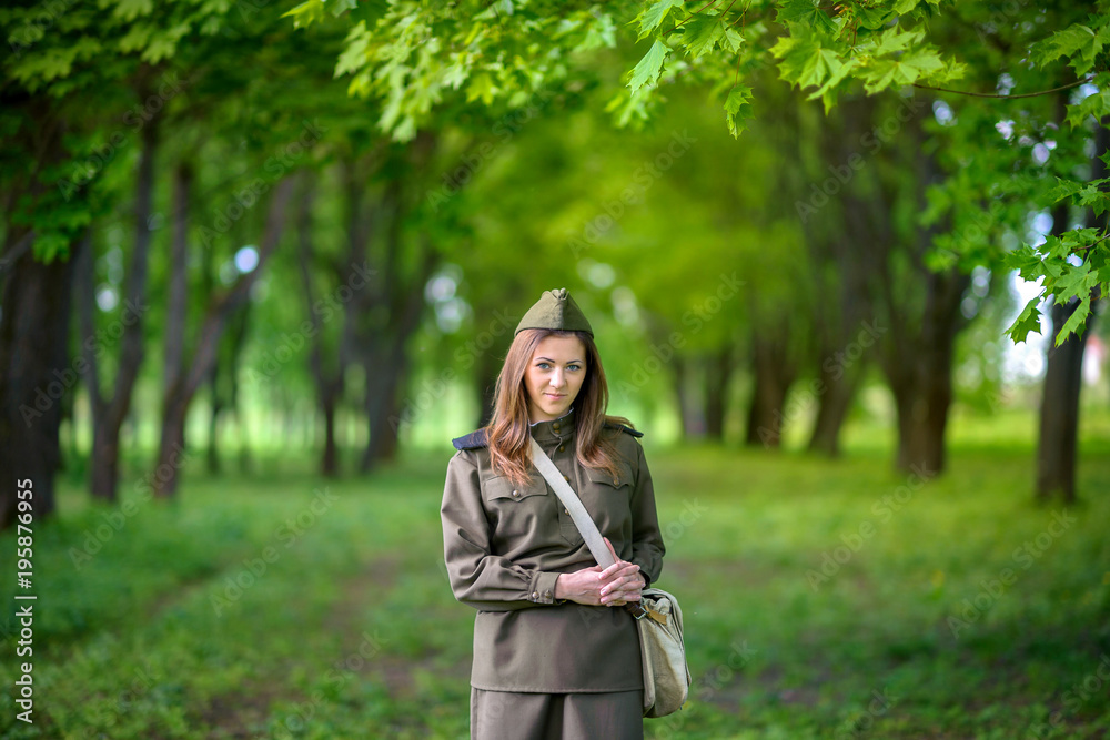 girl in military uniform in beautiful spring park girl in military uniform in beautiful spring park