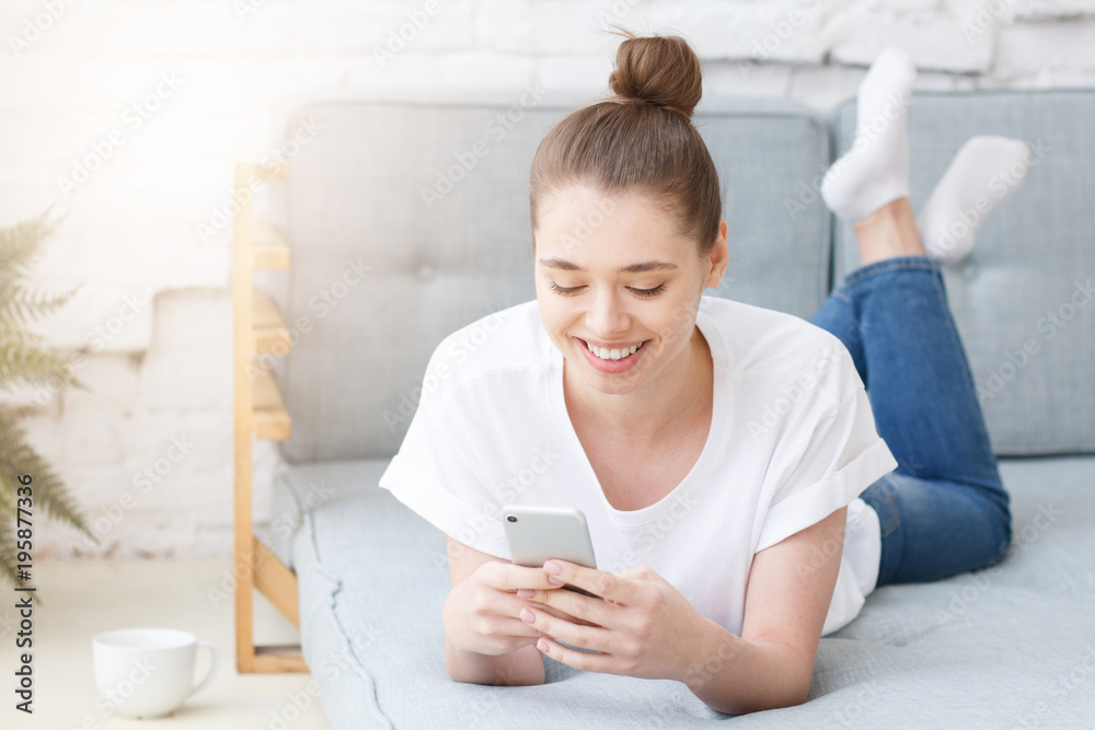 Happy joyful smiling young woman using smart phone Happy joyful smiling young woman using smart phone