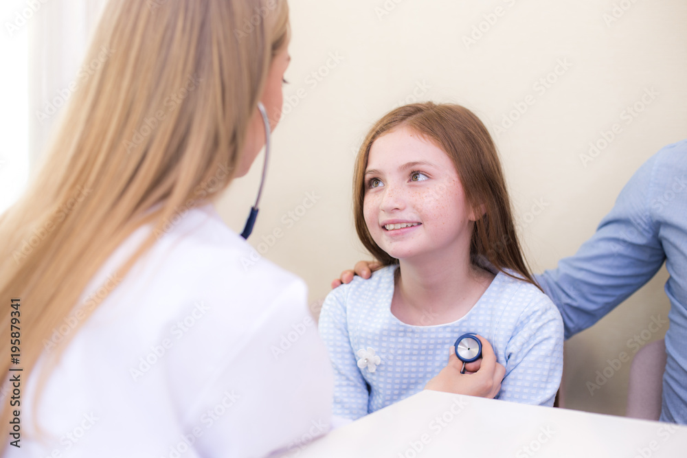 Attractive girl looking to doctor with happy emotion at clinic. Medical and Health care concept. Attractive girl looking to doctor with happy emotion at clinic. Medical and Health care concept.