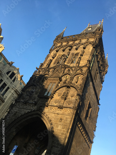 Facade of the Powder Tower (Prasna brana), medieval gate from the 15th Century in Prague, separating Old Town from New Town, Prague Czech Republic. Exterior of the Powder Tower lit with warm sunlight. photo