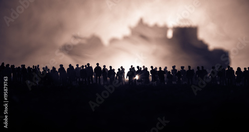 Valokuva Silhouettes of a crowd standing at blurred military war ship on foggy background