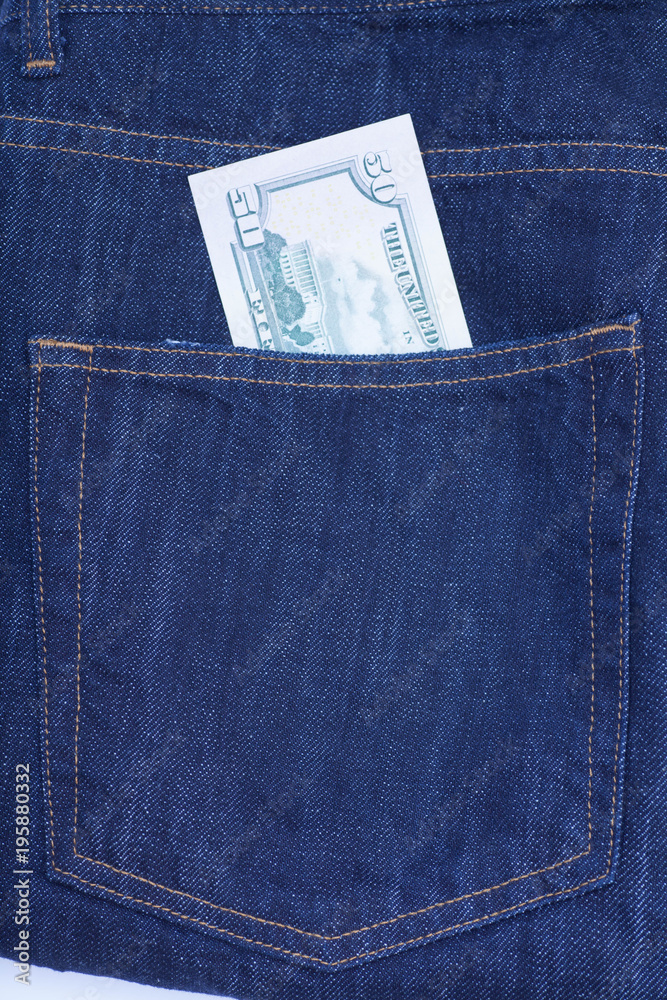 Fifty dollar bills sticking out of the pocket of denim jeans Fifty dollar bills sticking out of the pocket of denim jeans
