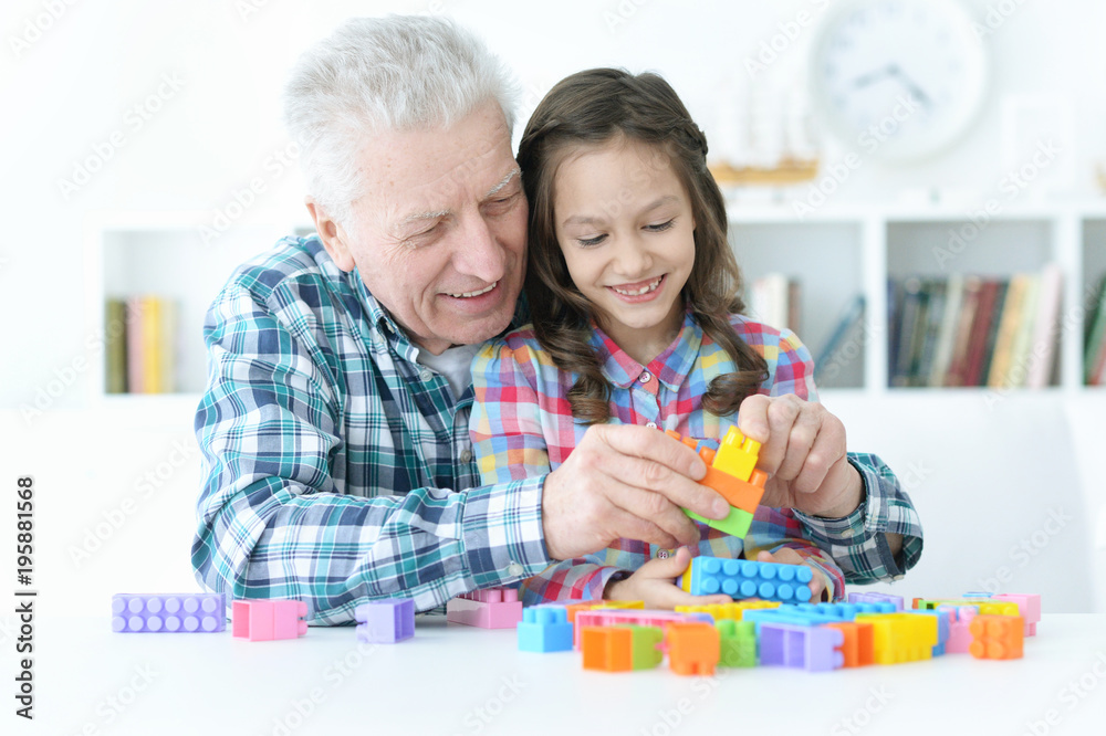Grandfather playing with her little granddaughter Grandfather playing with her little granddaughter