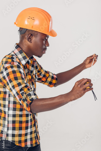 African-American builder uses measuring tape