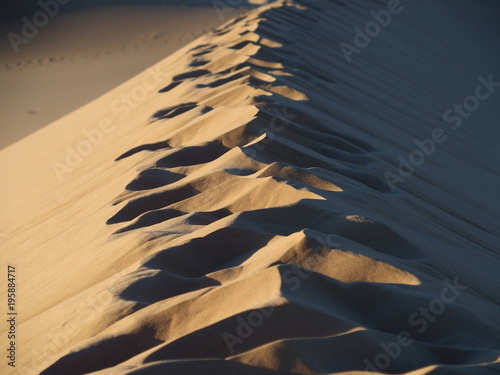 Footsteps on Sahara desert sandy ERG CHEBBI dunes range landscape at Merzouga village in MOROCCO photo