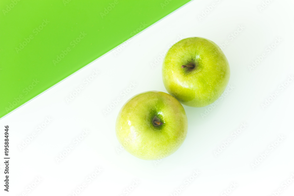 Green apple on the white-green glass background. Green apple on the white-green glass background.