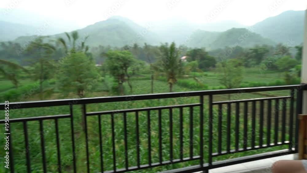 sad unhappy depressed devastated, waste, ruined man sitting alone on a balcony with wonderful green nature background view sad unhappy depressed devastated, waste, ruined man sitting alone on a balcony with wonderful green nature background view