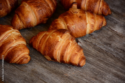 The freshly baked croissants  on wooden background