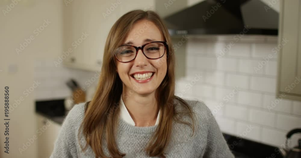 4K Cute girl wearing glasses laughing uncontrollably during video conference call
