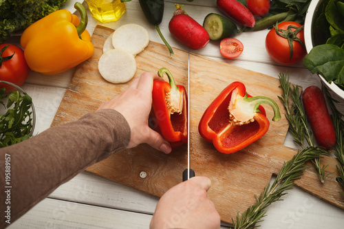 Woman's hand cutting fresh tomatoes