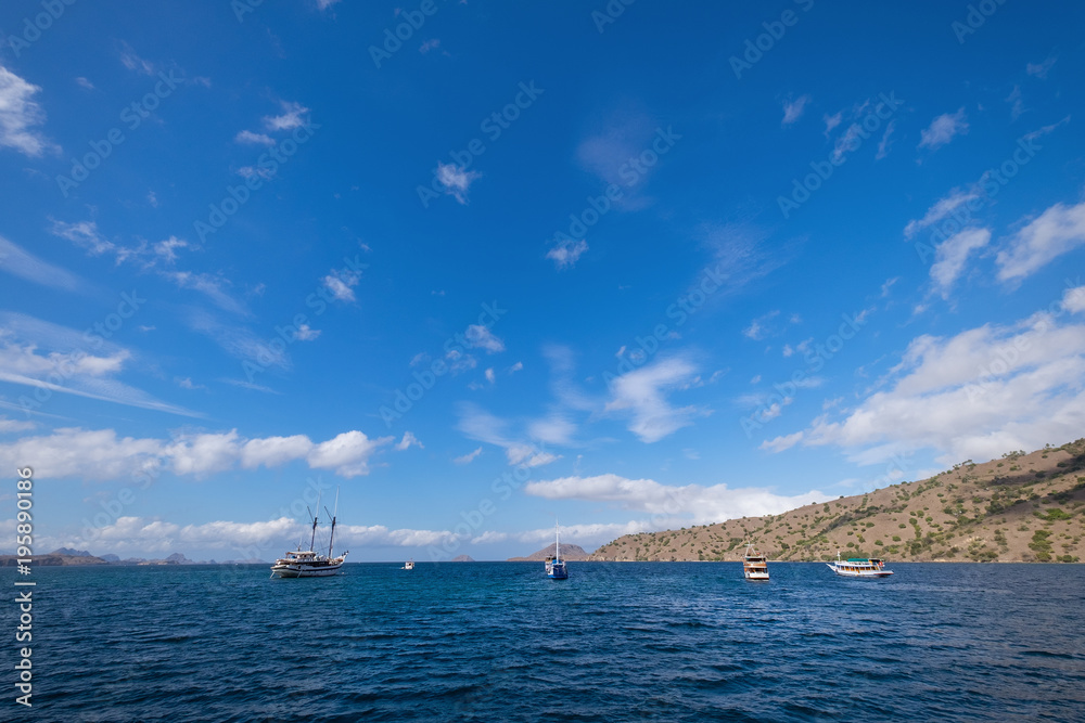 Blue sky background with white clouds on a sunny day over the sea in Komodo island, East Nusa Tenggara, Indonesia