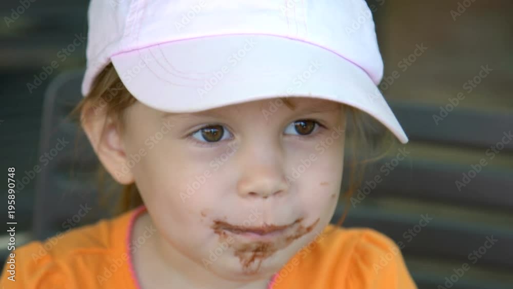Closeup of little girl eating ice cream and smiling Closeup of little girl eating ice cream and smiling