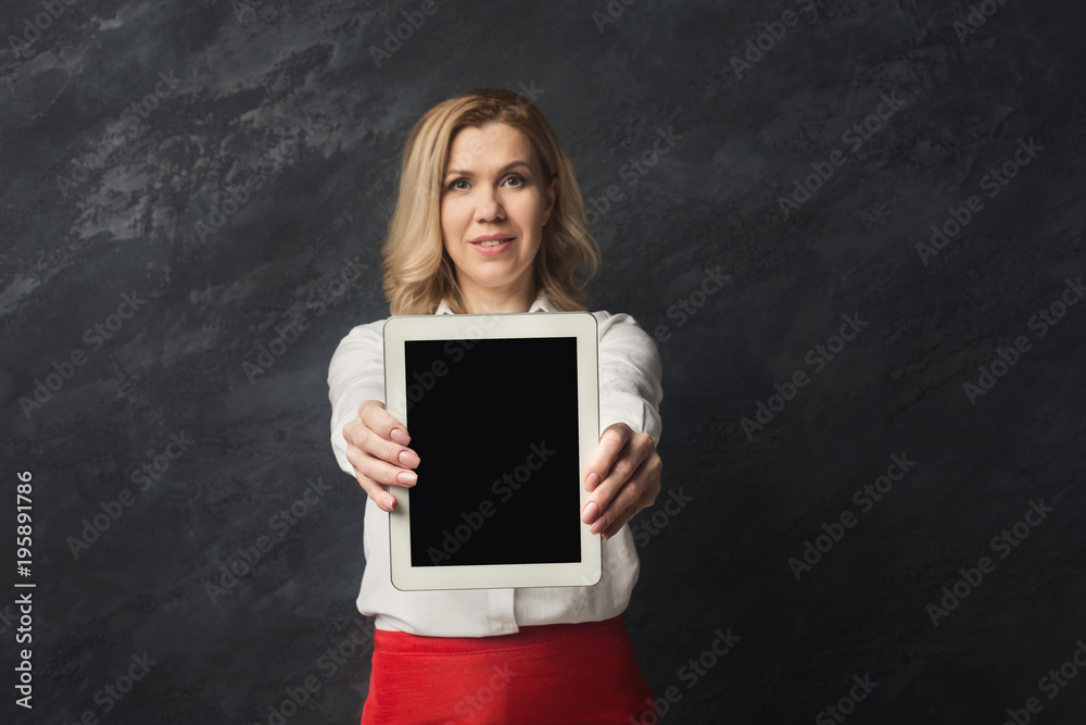 Smiling businesswoman presenting tablet screen Smiling businesswoman presenting tablet screen