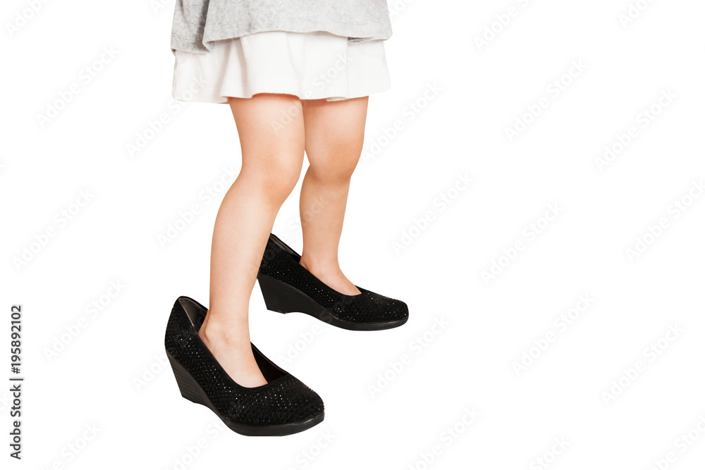 Little baby girl wearing big shoes. Isolated on white background. Little baby girl wearing big shoes. Isolated on white background.