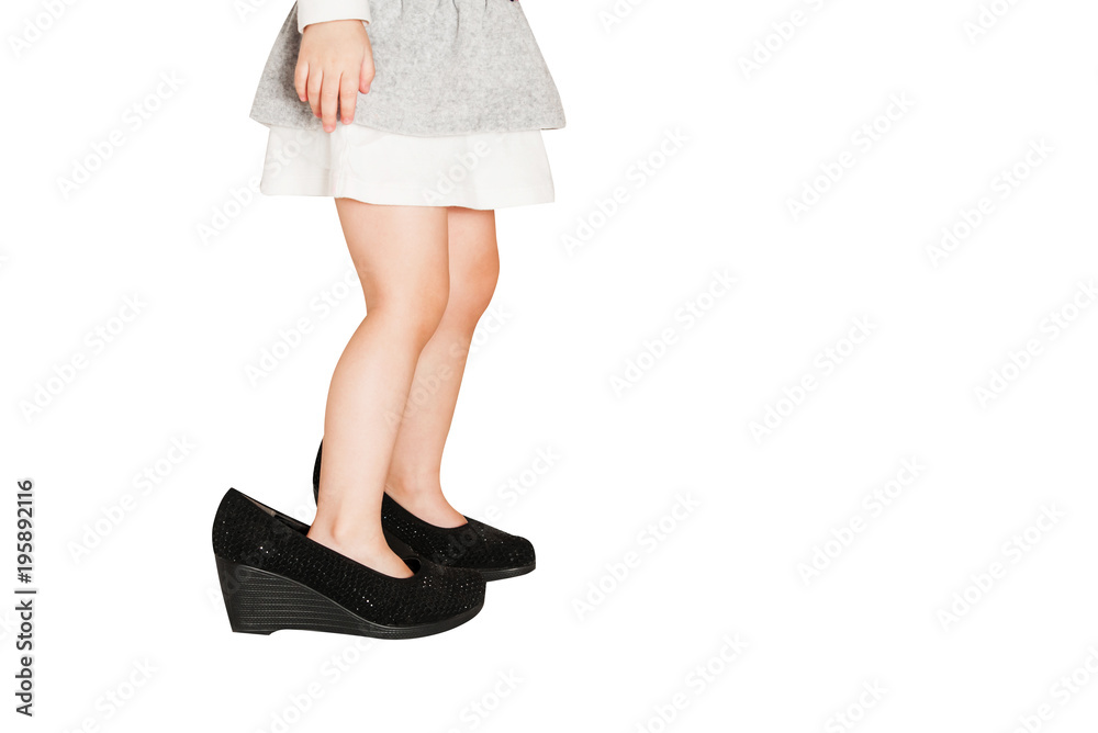 Little baby girl wearing big shoes. Isolated on white background. Little baby girl wearing big shoes. Isolated on white background.