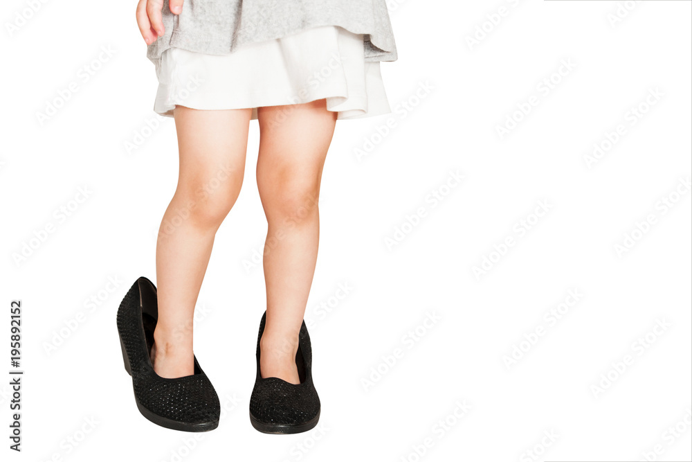 Little baby girl wearing big shoes. Isolated on white background. Little baby girl wearing big shoes. Isolated on white background.