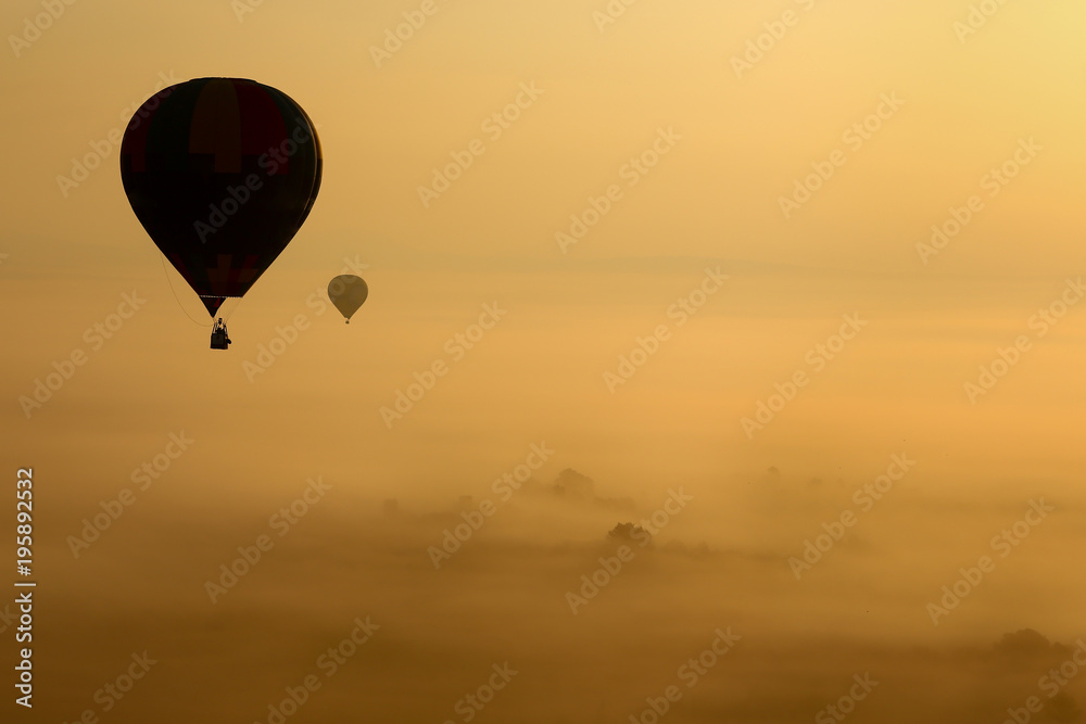 Hot air balloons, atmosphere ballons flying over mountain landscape at Mallorca in the sunrise Hot air balloons, atmosphere ballons flying over mountain landscape at Mallorca in the sunrise