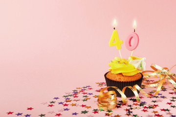40th birthday cupcake with candle and sprinkles
