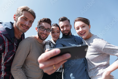 group of young people taking a selfie.