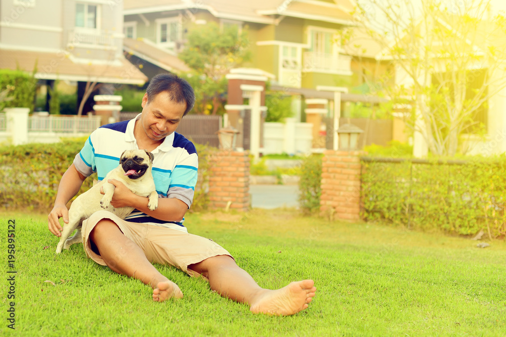Happy Asian man playing with his dog in garden
Happy Asian man playing with his dog in garden