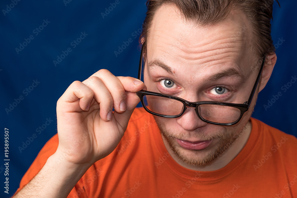 portrait of a man who looks over his glasses portrait of a man who looks over his glasses