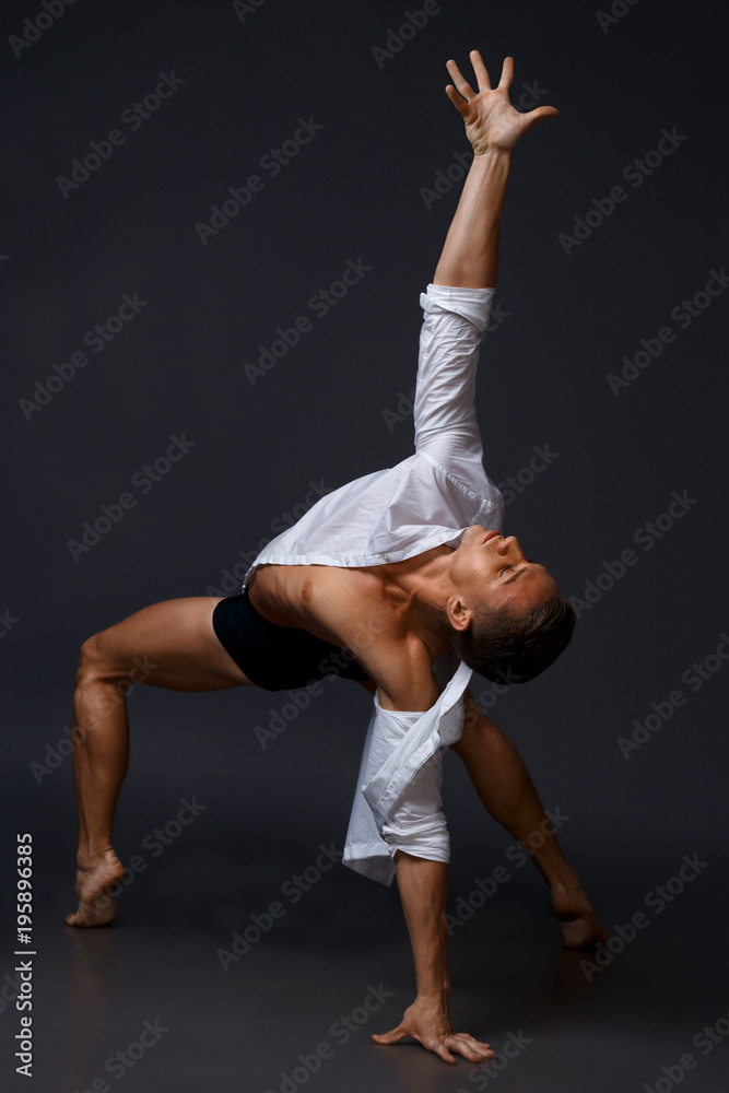 dancer dances in a white shirt and black shorts