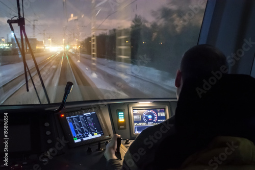 View from the driver's cab of an electric train, a night voyage on a railway.