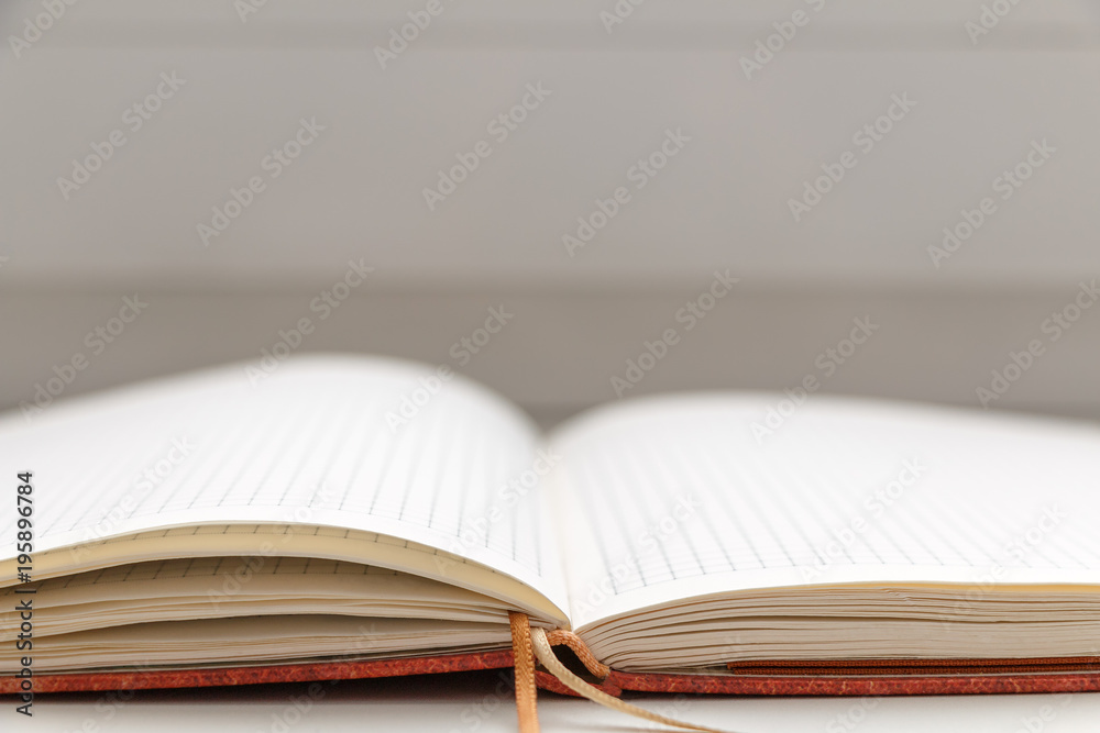 Open blank notepad on white background close-up Open blank notepad on white background close-up
