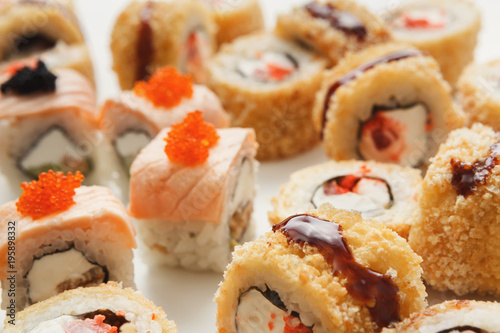 Closeup of sushi rolls on white background