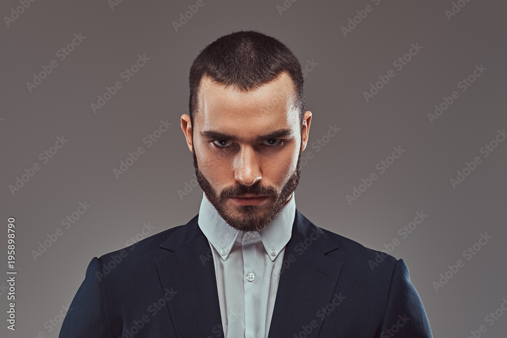 Studio portrait of a brutal bearded businessman wearing a formal