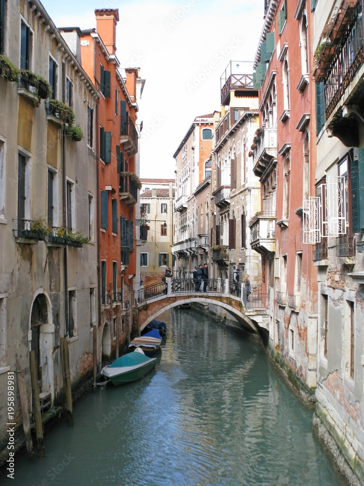 Venice. Cozy narrow street. Windows with shutters. Balconies. A charming romantic setting.