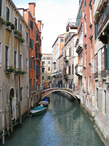 Venice. Cozy narrow street. Windows with shutters. Balconies. A charming romantic setting. © Yevgen