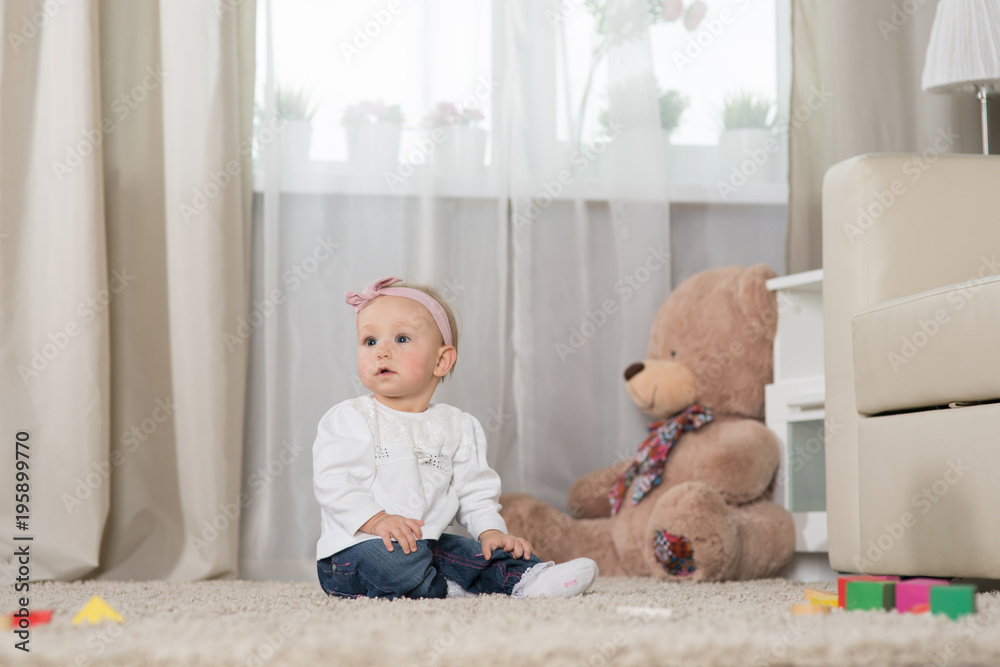Baby eight months playing in the room Baby eight months playing in the room