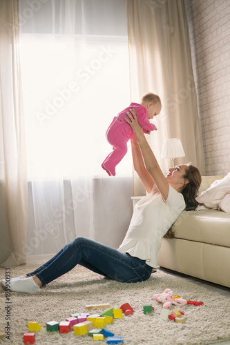 young mother plays with a baby.