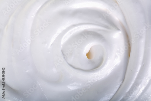close up of a white whipped or sour cream on white background