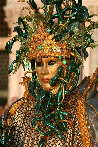 green and gold masquerade mask at Venice carnival Italy