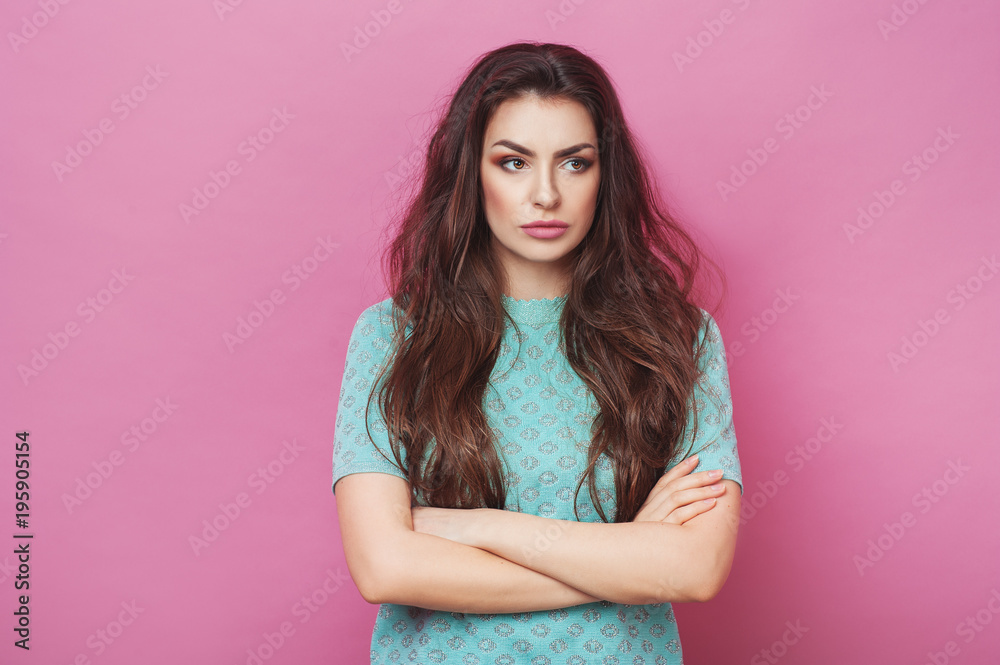Portrait of displeased upset angry female, being discontent and unhappy as can`t achieve goals, isolated over pink studio background. Dissapointed young woman has troubles. Fashion Lifestyle Beauty
